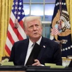 
President Donald Trump signs documents as he issues executive orders and pardons for Jan. 6 defendants in the Oval Office on Jan. 20, 2025.